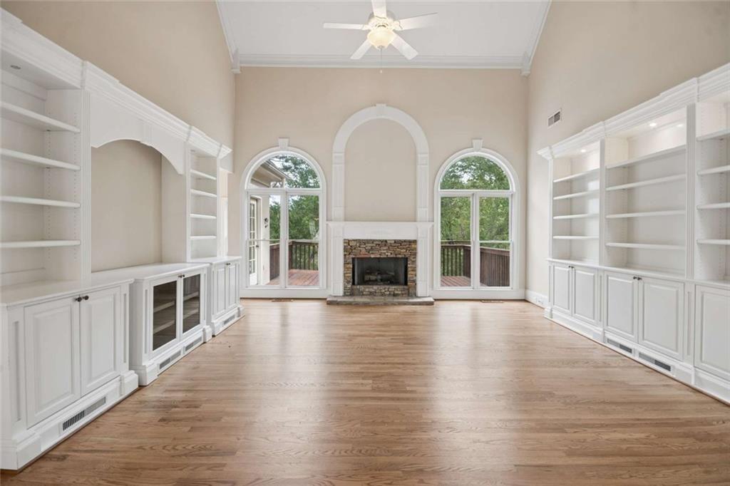 2628 High Street Southwest Conyers, GA 30094 - Photo 22 of 53 an empty room with wooden floor fireplace and windows