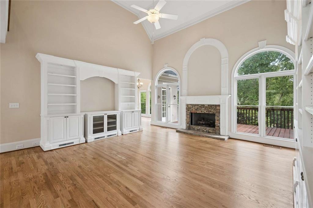 2628 High Street Southwest Conyers, GA 30094 - Photo 23 of 53 an empty room with wooden floor fireplace and windows