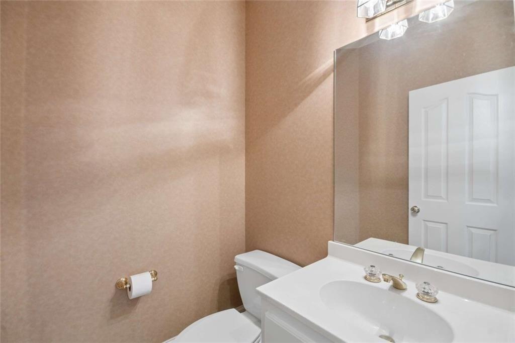 2628 High Street Southwest Conyers, GA 30094 - Photo 24 of 53 a bathroom with a sink mirror and toilet