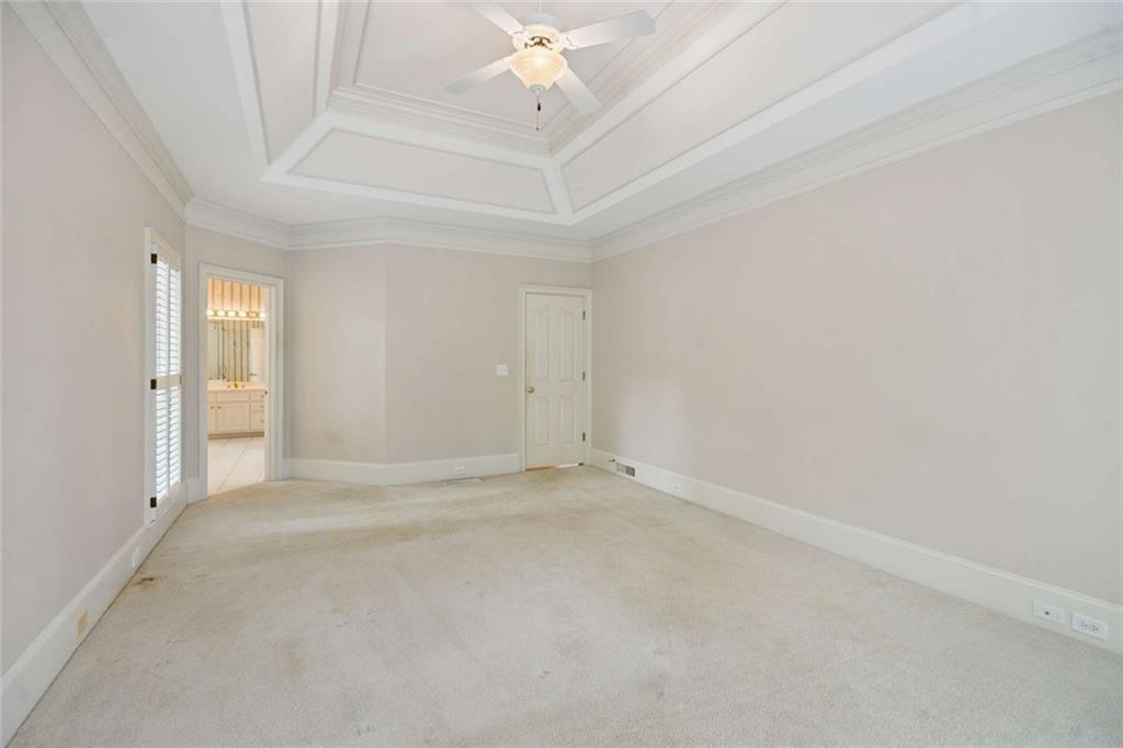 2628 High Street Southwest Conyers, GA 30094 - Photo 26 of 53 an empty room with a chandelier fan and windows