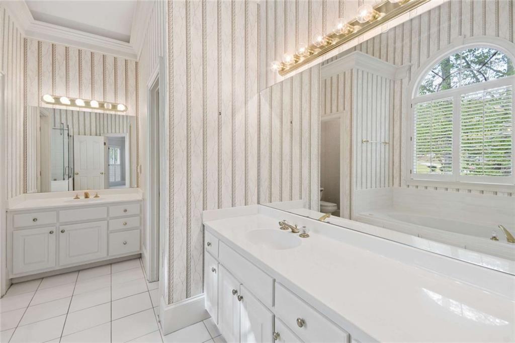 2628 High Street Southwest Conyers, GA 30094 - Photo 28 of 53 a spacious bathroom with a double vanity sink a mirror and a bathtub