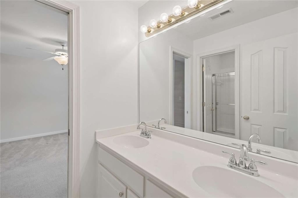 2628 High Street Southwest Conyers, GA 30094 - Photo 33 of 53 a bathroom with a sink and a mirror