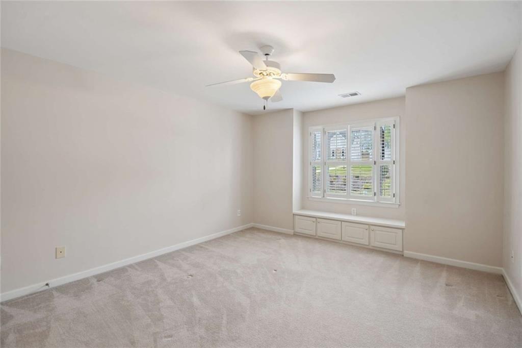 2628 High Street Southwest Conyers, GA 30094 - Photo 35 of 53 an empty room with window and ceiling fan