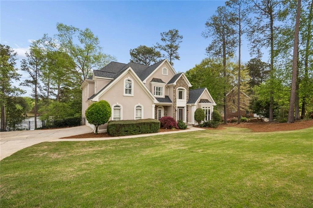 2628 High Street Southwest Conyers, GA 30094 - Photo 6 of 53 a front view of a house with a yard and garage