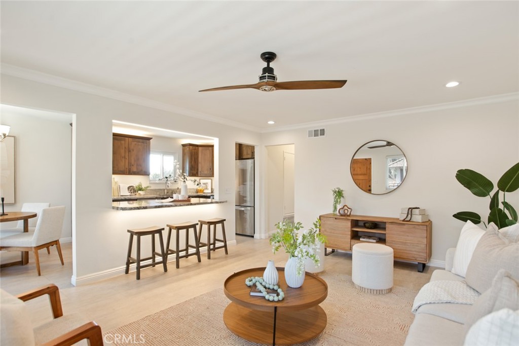3636 South Main Street, Unit D Santa Ana, CA 92707 - Photo 1 of 1 a living room with furniture a clock and a chandelier