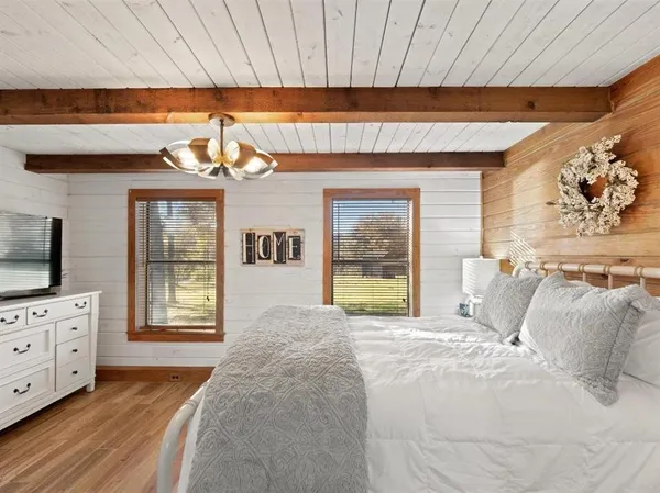 a bed room with a bed and a television