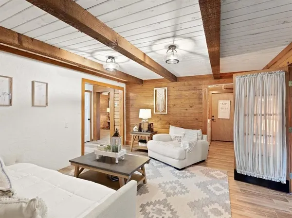 a living room with furniture and wooden floor