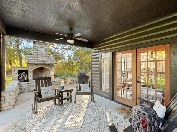 a living room with furniture a flat screen tv and a floor to ceiling window
