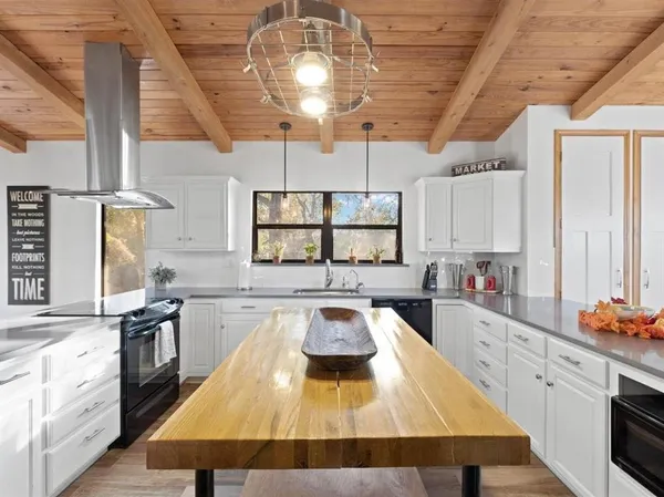 a kitchen with a table chairs stove and cabinets