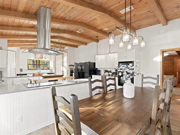 a kitchen with lots of counter top space and dining table