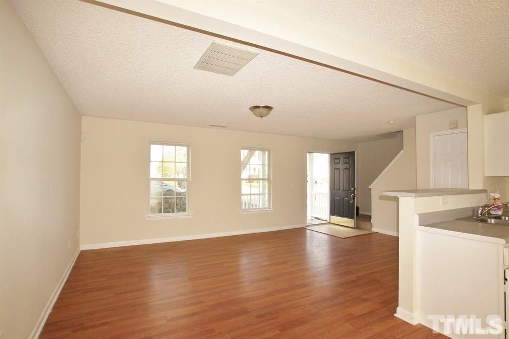5505 Marthonna Way Raleigh, NC 27616 - Photo 3 of 3 a view of an empty room with wooden floor and a window
