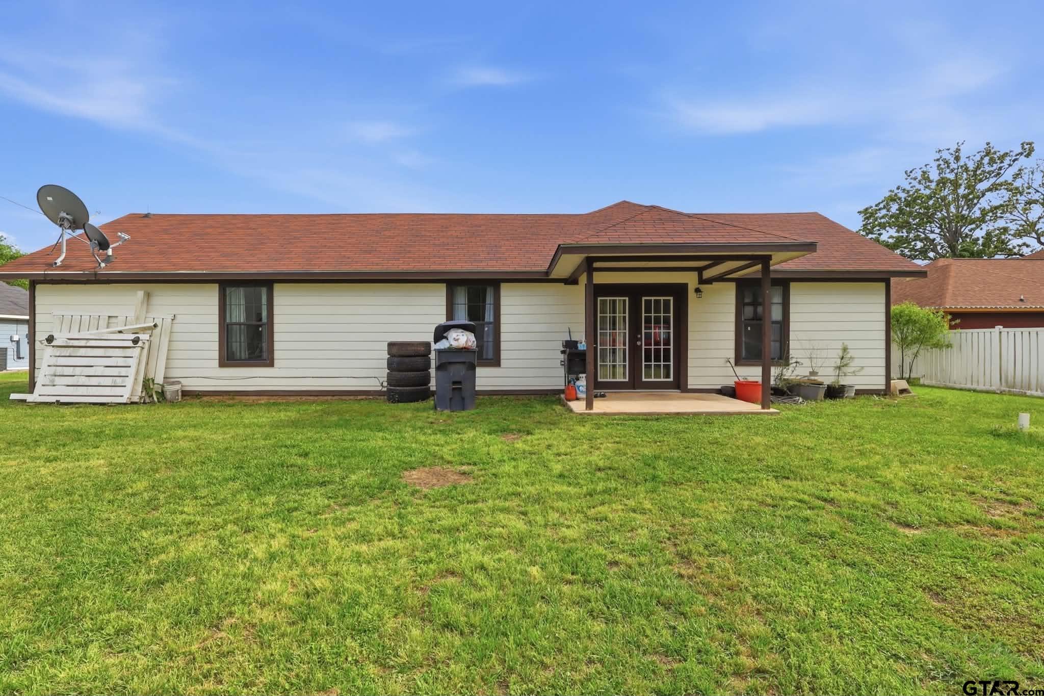 1933 Highway 11 Pittsburg, TX 75686 - Photo 21 of 34 a front view of a house with a garden and porch