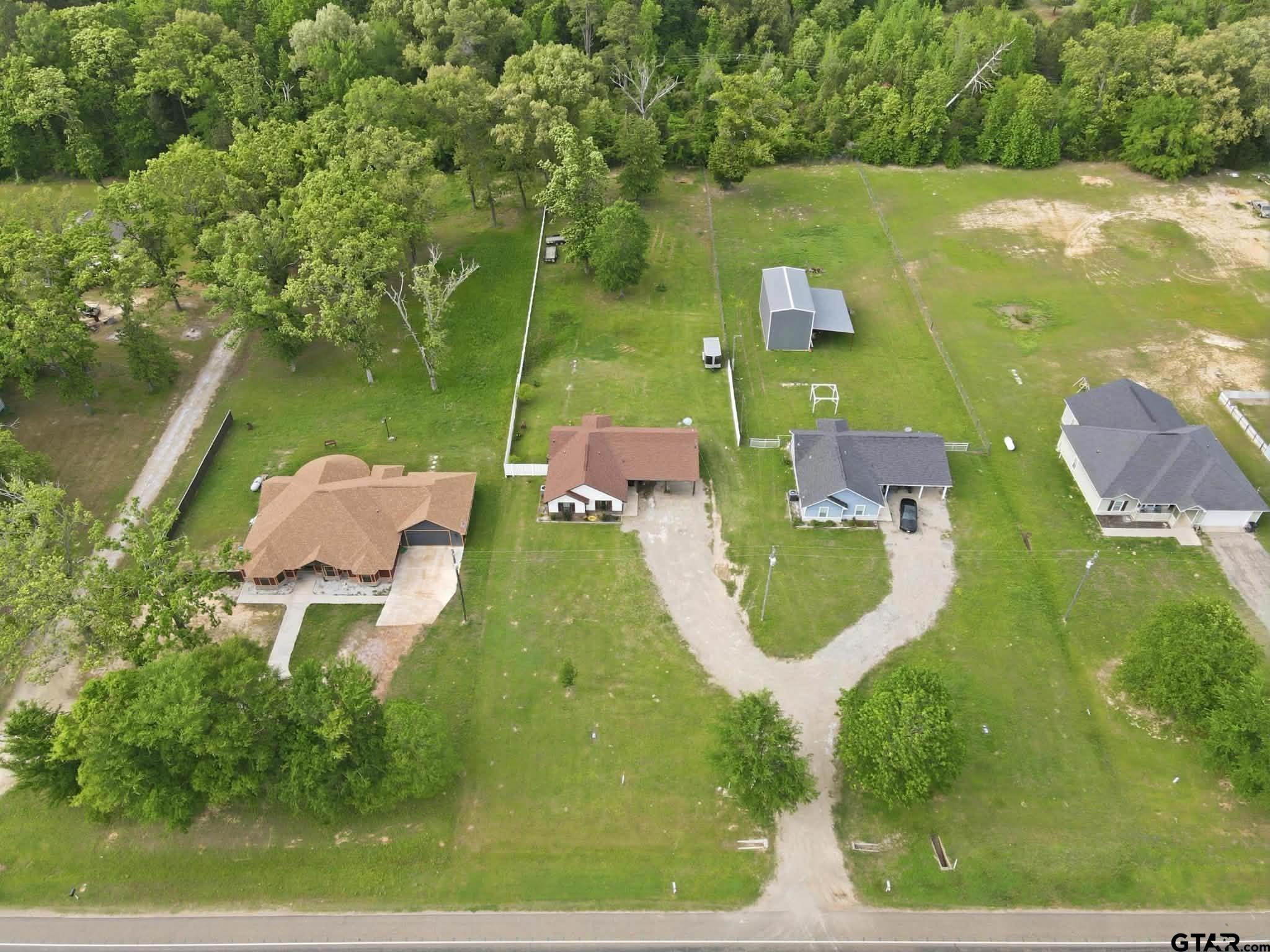 1933 Highway 11 Pittsburg, TX 75686 - Photo 29 of 34 an aerial view of a house with a garden and lake view