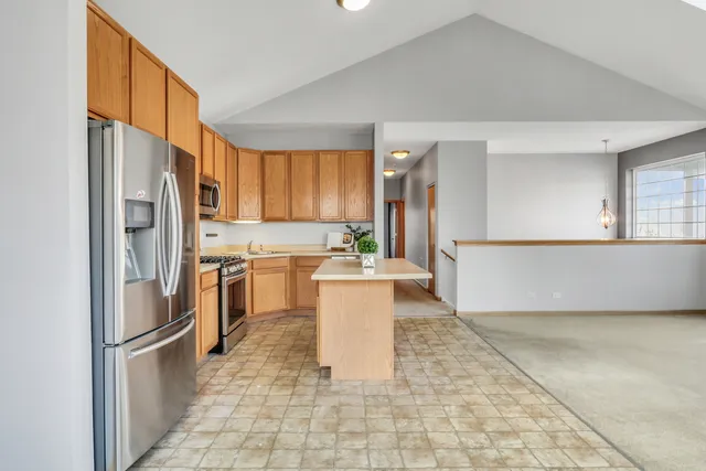 a kitchen with a refrigerator a stove top oven and a sink