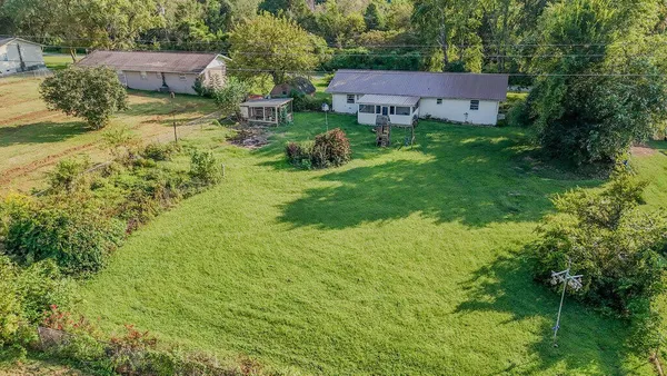 a backyard of a house with yard and outdoor seating