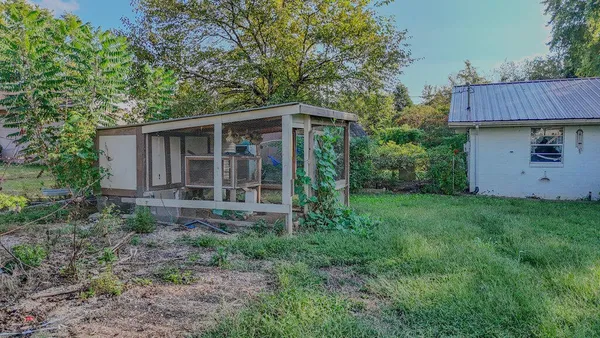 a view of a house with yard and sitting area