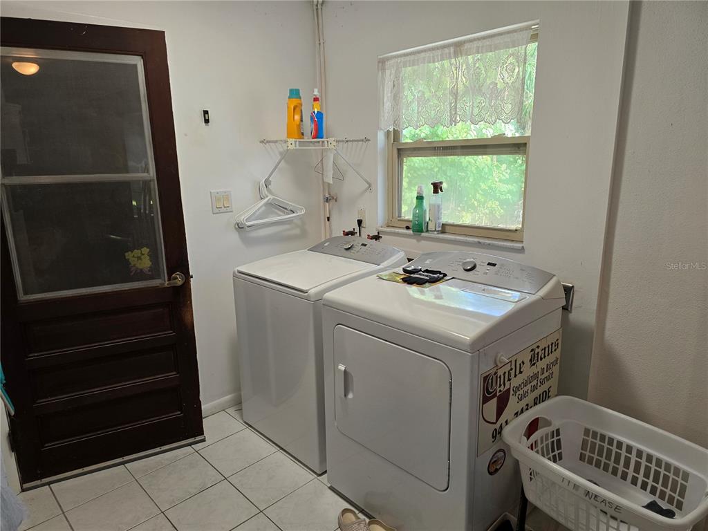 22200 Oneida Avenue Port Charlotte, FL 33952 - Photo 19 of 26 a utility room with dryer and washer