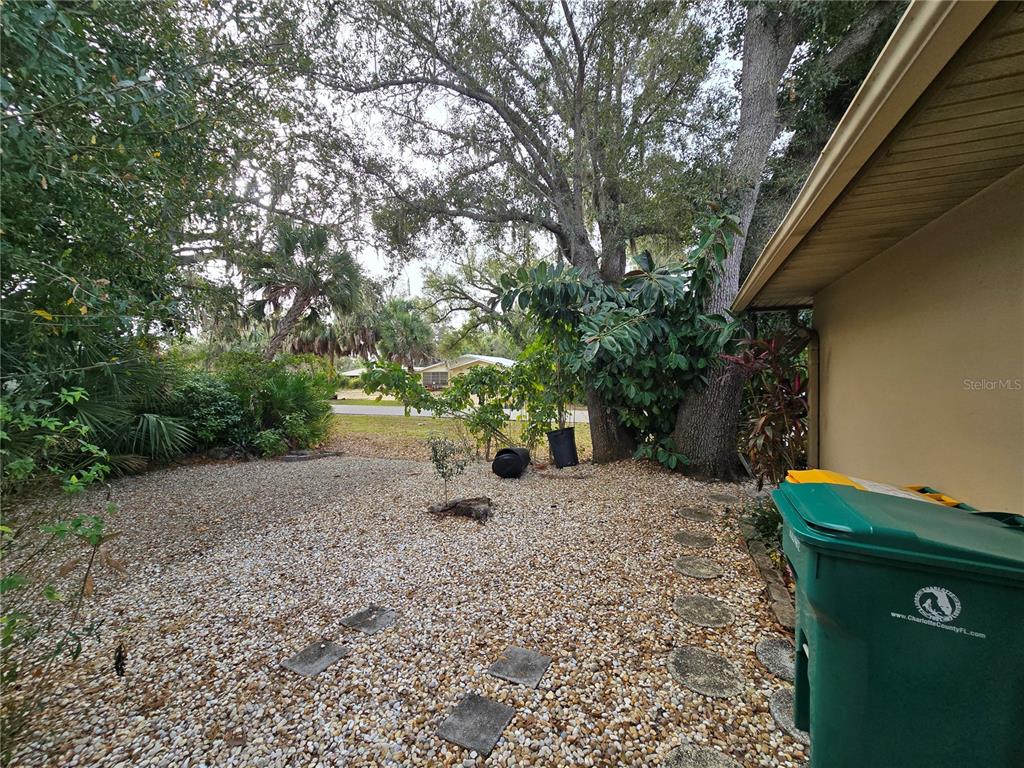 22200 Oneida Avenue Port Charlotte, FL 33952 - Photo 24 of 26 a backyard of a house with lots of green space