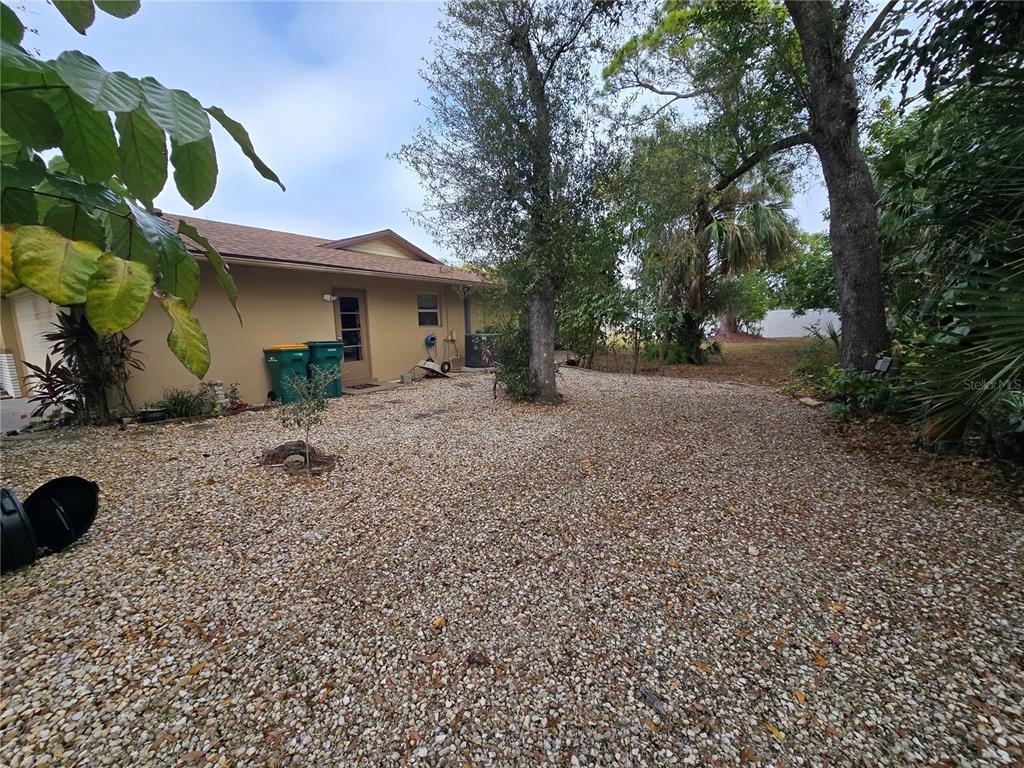 22200 Oneida Avenue Port Charlotte, FL 33952 - Photo 3 of 26 a front view of a house with a yard