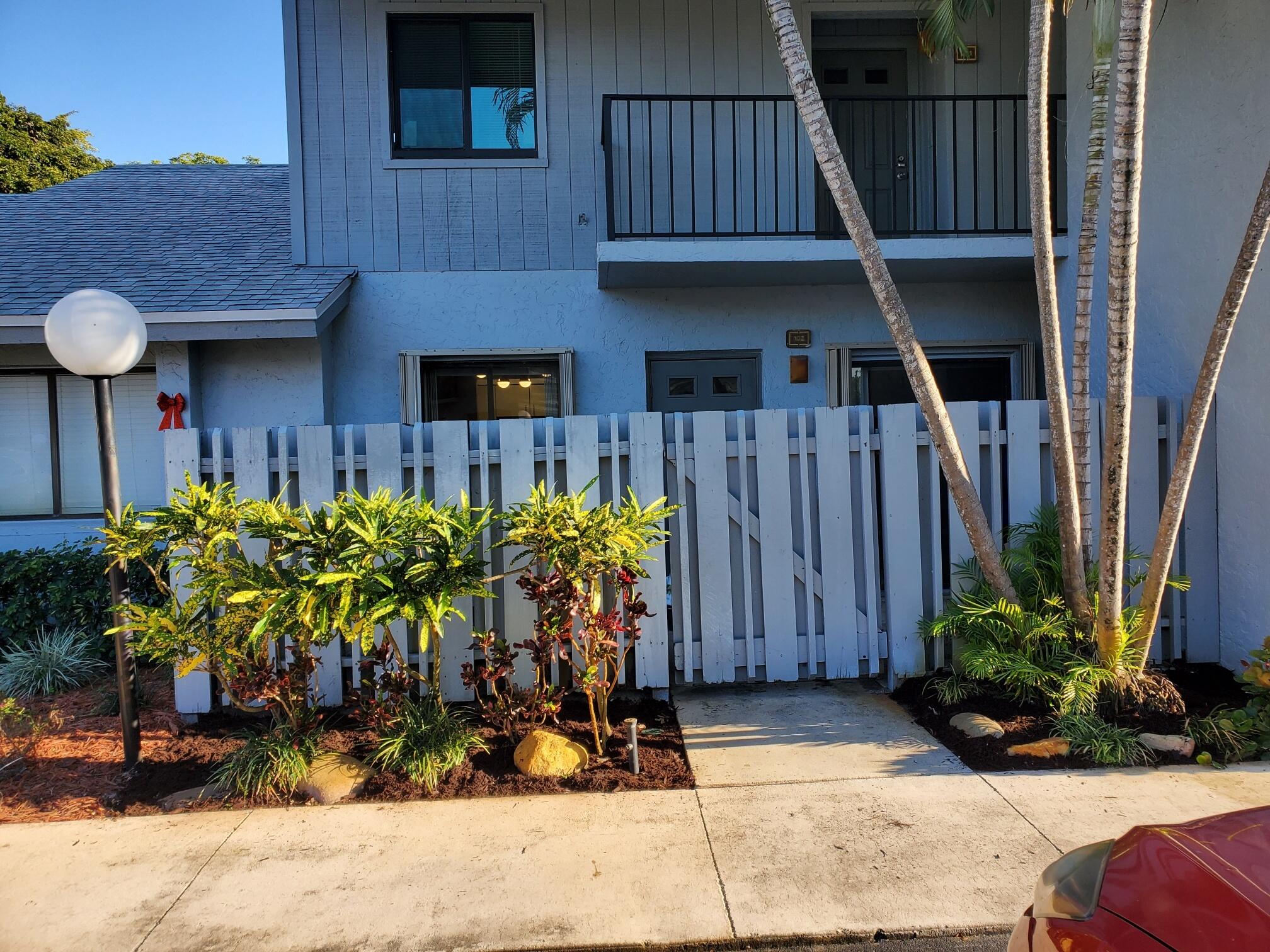 2445 Southwest 22nd Avenue, Unit 1020 Delray Beach, FL 33445 - Photo 2 of 37 a couple of table and chairs in front of house