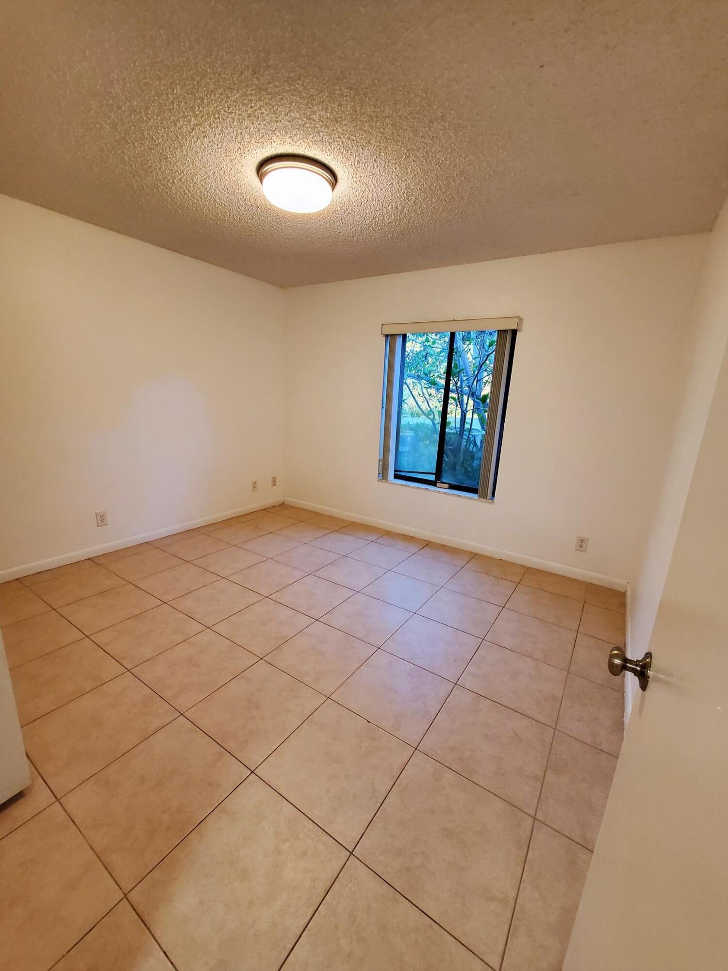 2445 Southwest 22nd Avenue, Unit 1020 Delray Beach, FL 33445 - Photo 26 of 37 a view of an empty room and a window