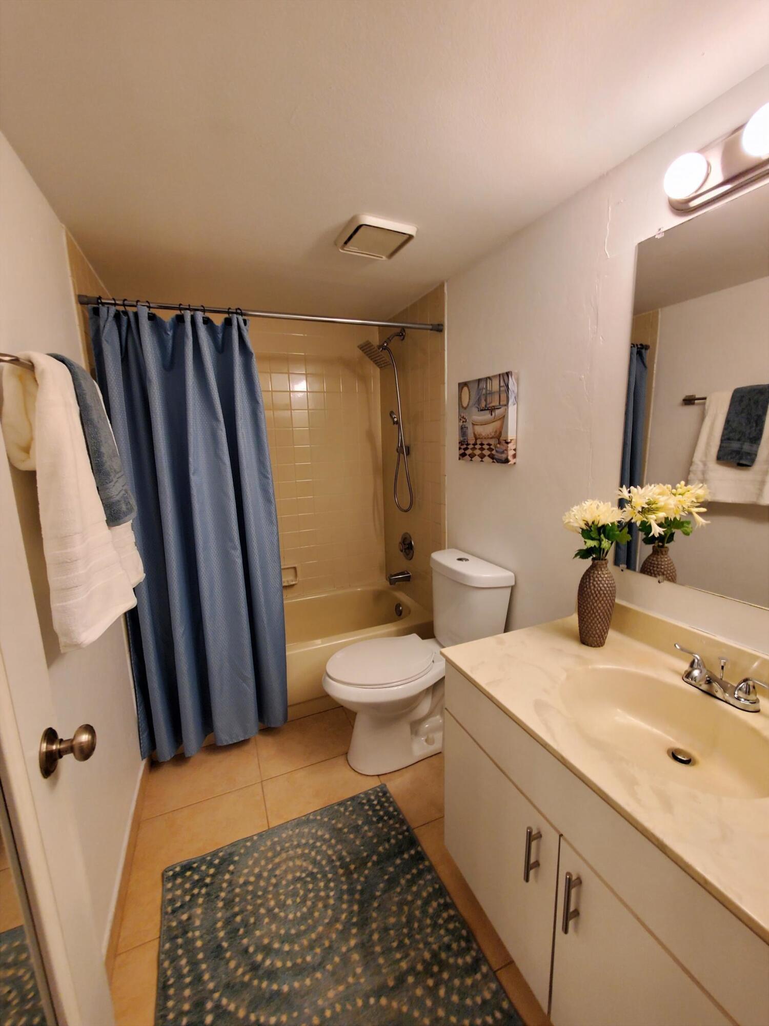 2445 Southwest 22nd Avenue, Unit 1020 Delray Beach, FL 33445 - Photo 32 of 37 a bathroom with a sink toilet and shower