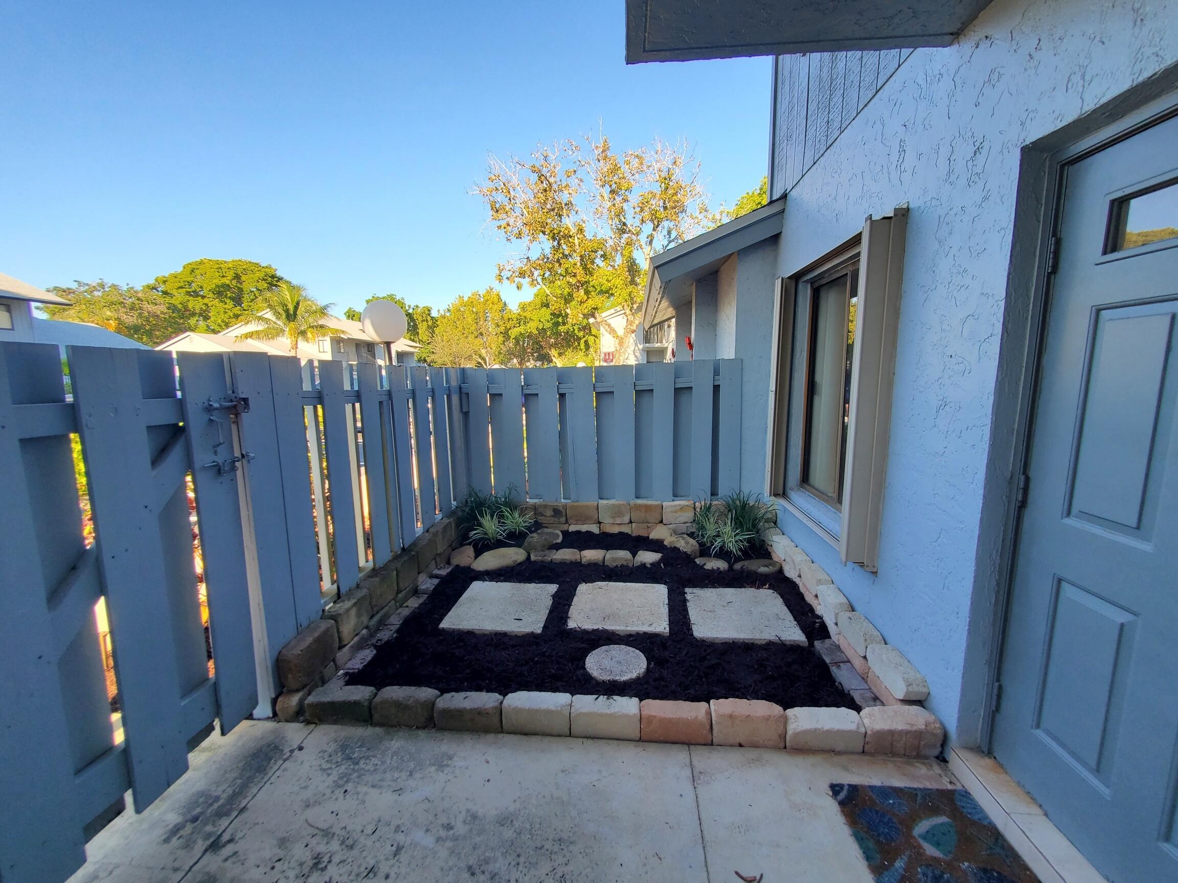 2445 Southwest 22nd Avenue, Unit 1020 Delray Beach, FL 33445 - Photo 6 of 37 a view of a backyard with open kitchen