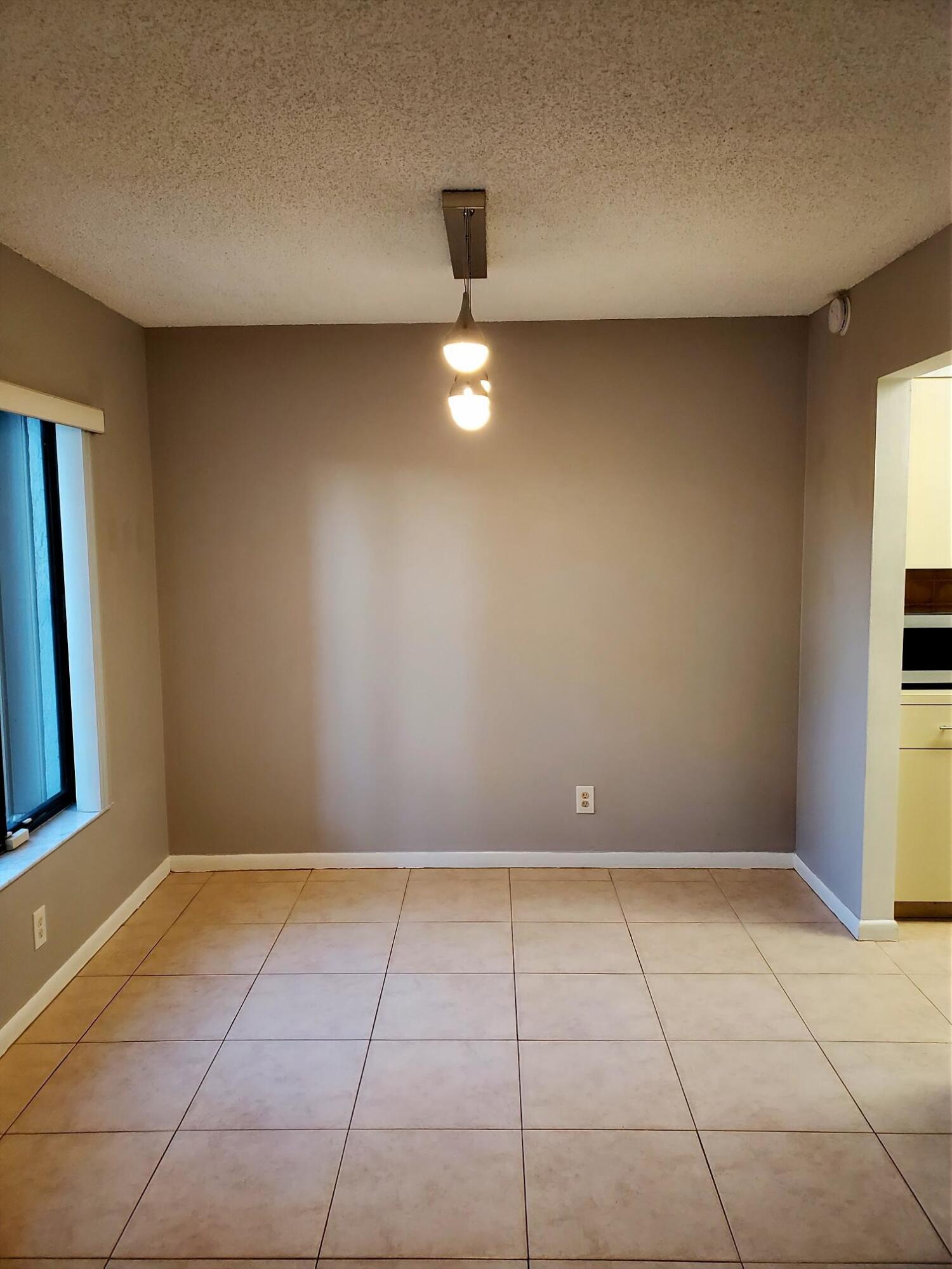 2445 Southwest 22nd Avenue, Unit 1020 Delray Beach, FL 33445 - Photo 10 of 37 a view of an empty room with a window