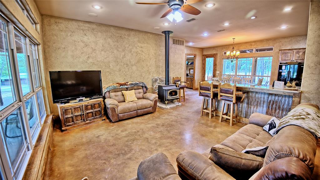 4509 Lazy E Road St. Jo, TX 76265 - Photo 7 of 39 a living room with furniture and a flat screen tv