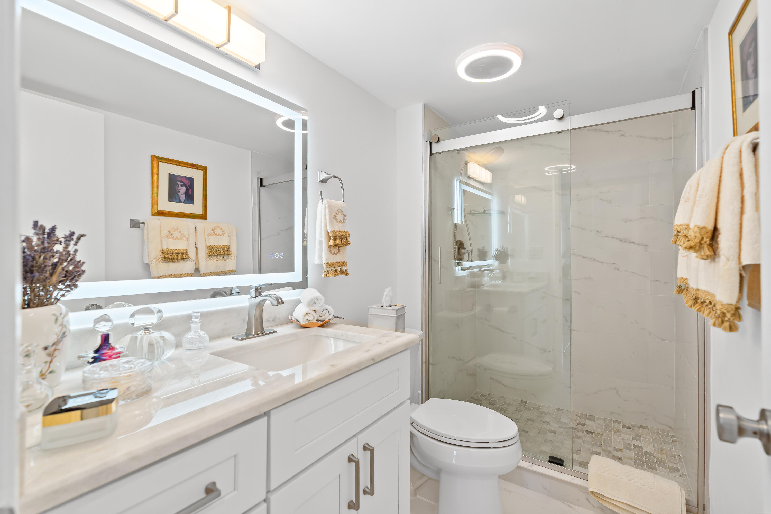 23200 Camino Del Mar, Unit 603 Boca Raton, FL 33433 - Photo 25 of 43 a bathroom with a sink vanity granite and toilet