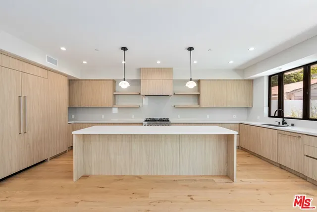 a large kitchen with stainless steel appliances lots of counter space