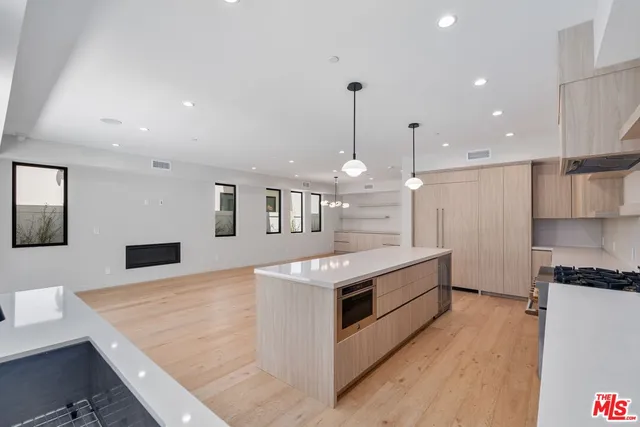 a large kitchen with stainless steel appliances granite countertop a large counter top and a stove