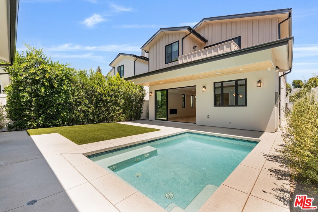 4647 Morse Avenue Sherman Oaks, CA 91423 - Photo 19 of 47 a view of a white house with a yard patio and a table and chairs