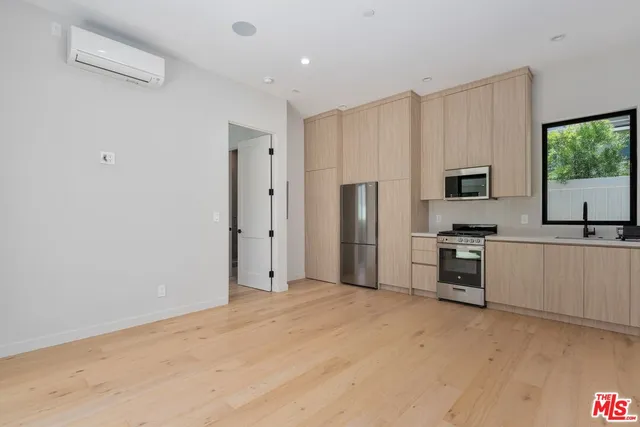 a kitchen with stainless steel appliances a refrigerator and a stove top oven