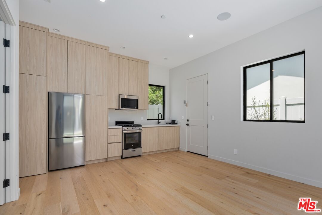 4647 Morse Avenue Sherman Oaks, CA 91423 - Photo 21 of 47 a kitchen with a refrigerator and a stove top oven