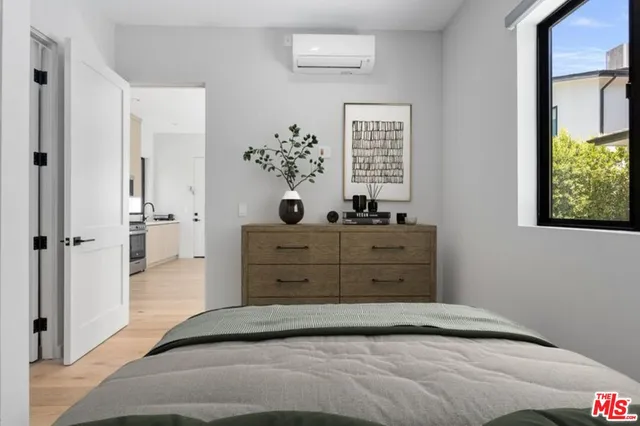 a bedroom with a bed and a window