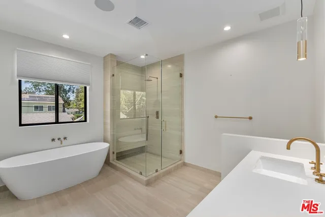 a bathroom with a bathtub and a shower