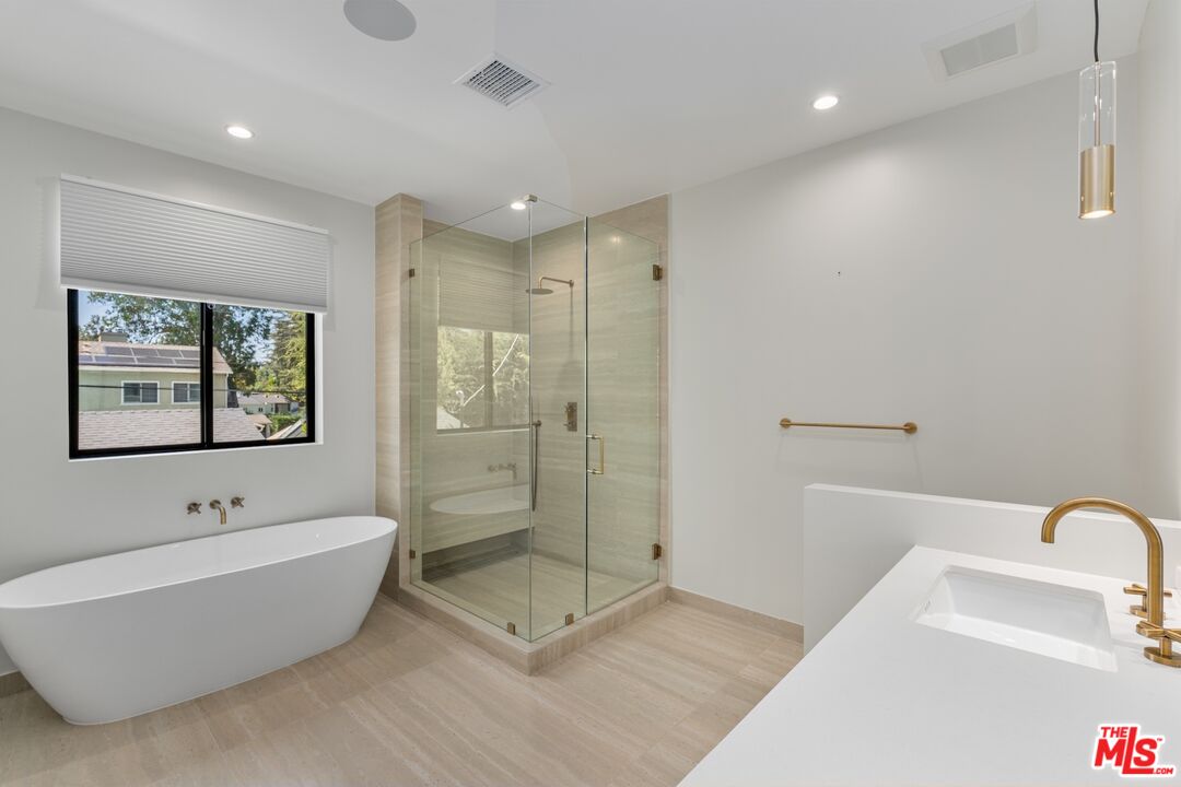 4647 Morse Avenue Sherman Oaks, CA 91423 - Photo 37 of 47 a bathroom with a bathtub and a shower