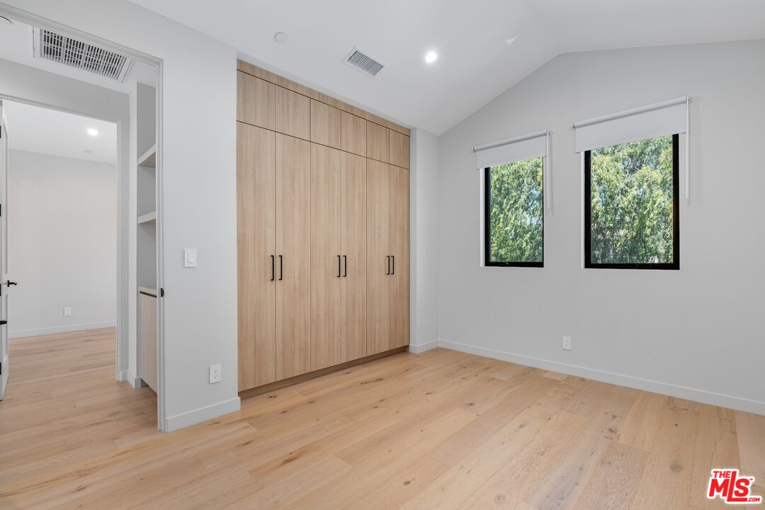 4647 Morse Avenue Sherman Oaks, CA 91423 - Photo 40 of 47 an empty room with wooden floor and windows