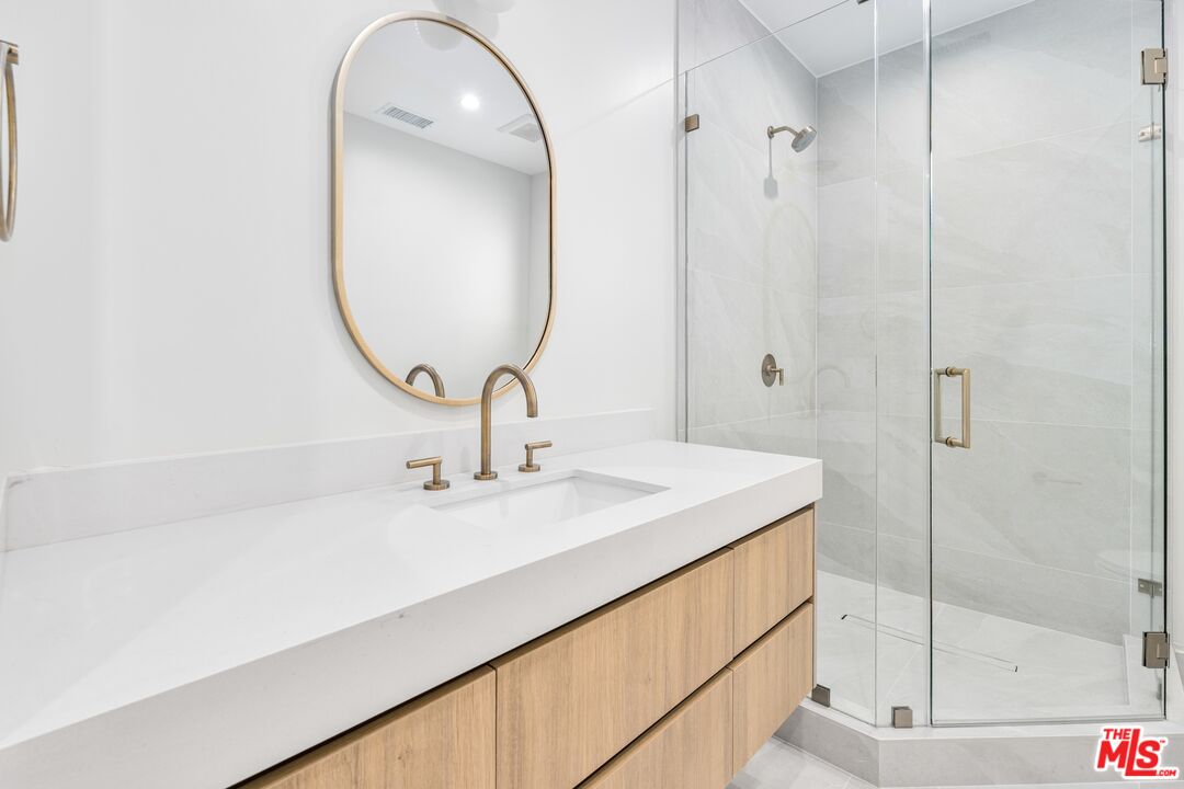 4647 Morse Avenue Sherman Oaks, CA 91423 - Photo 5 of 47 a bathroom with a sink and a mirror