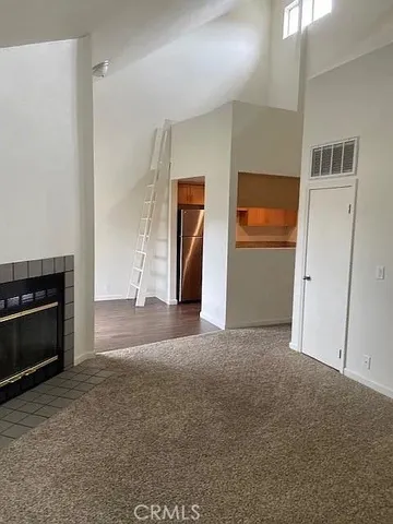 a view of empty room with a fireplace
