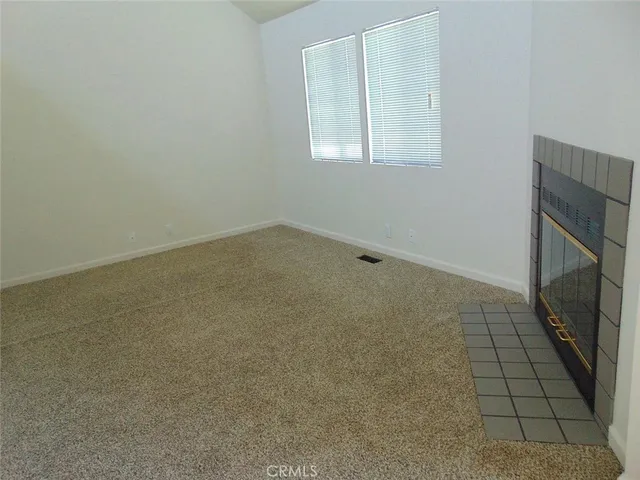 an empty room with a fireplace