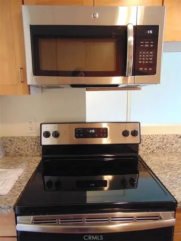 a stove top oven sitting inside of a kitchen