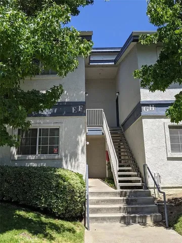 a view of a house with a white fence