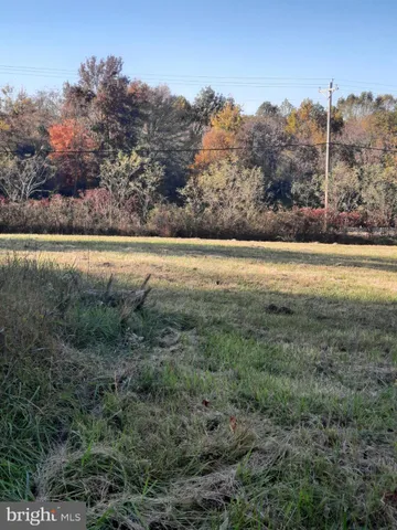 a view of a field with an ocean view