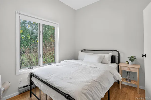 a bedroom with a bed and a window