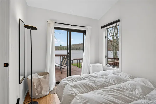 a bedroom with a bed and a large window