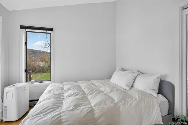 a bedroom with a bed and a window