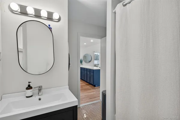 a bathroom with a sink and a mirror