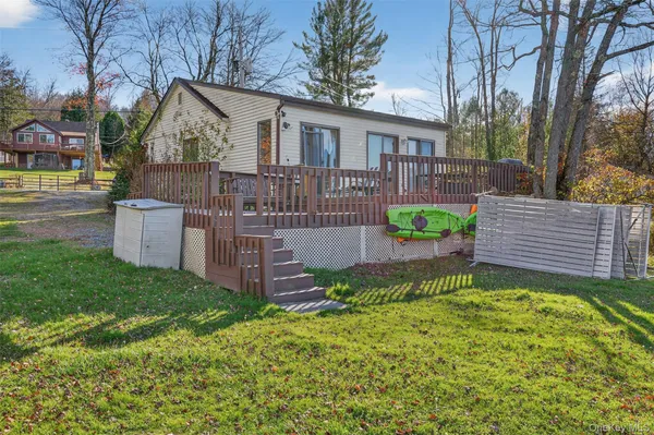 a view of a house with a yard and sitting area